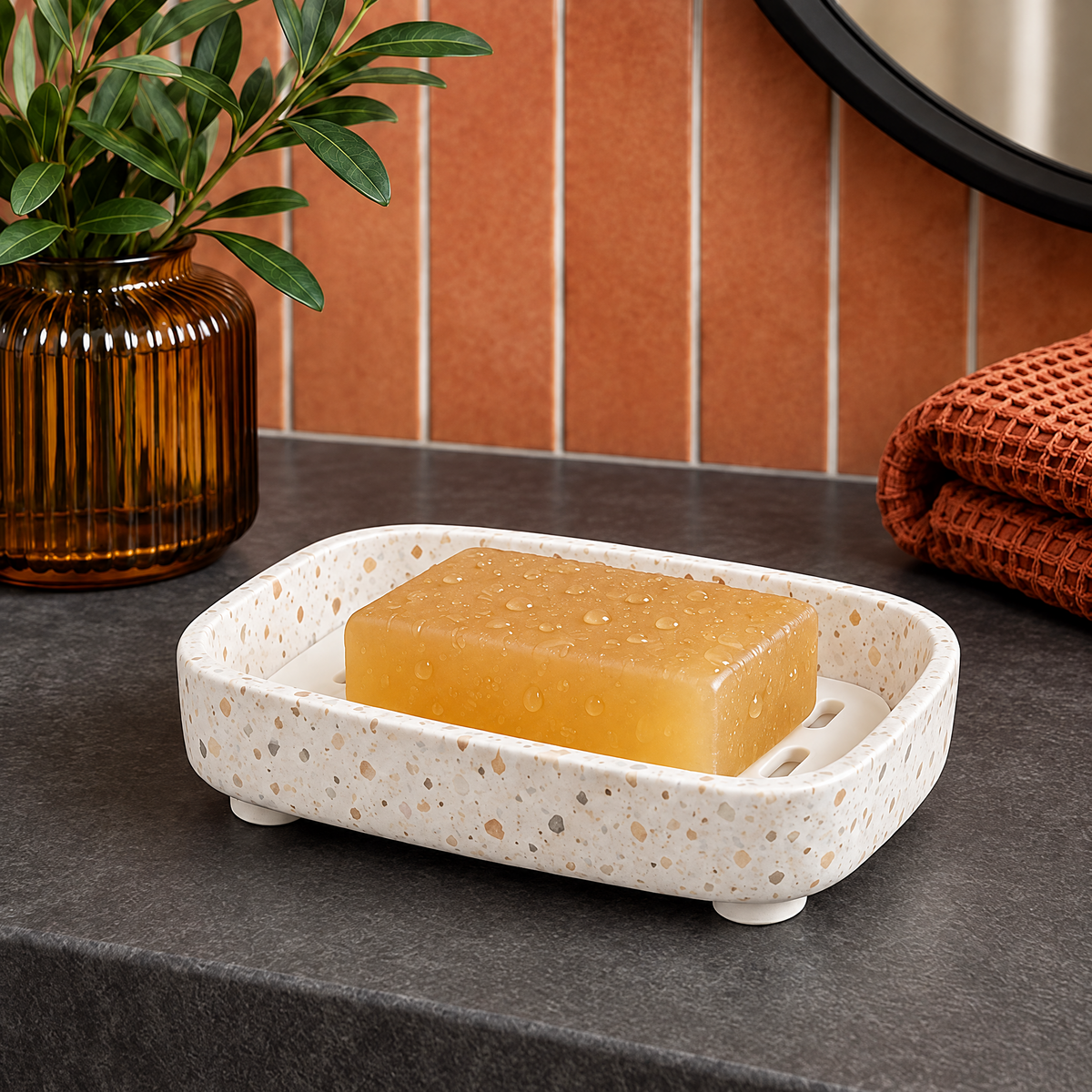 Jorlenna Cream Speckle Soap Tray — holding a bar of soap